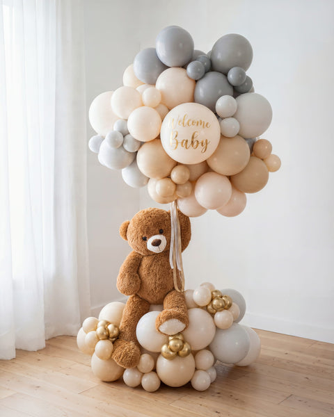 Columna de globos "Teddy's Journey" para baby shower con oso de peluche en gris, crema y dorado, "Welcome Baby" — Perú Balloons, Lima