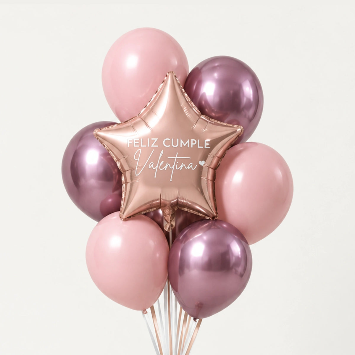 Bouquet de globos rosas y cromados con estrella oro rosa que dice Feliz cumple Valentina, sobre fondo claro.