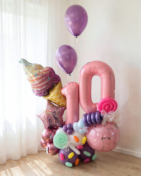 Bouquet escultural "Dulce Fantasía" para cumpleaños número 10 en rosa y morado con helado, dulces y estrellas — Perú Balloons, Lima