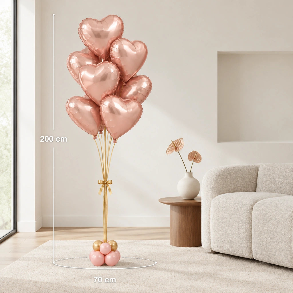 Ramo de globos de corazón oro rosa en una sala, con medidas indicadas de 200 cm de alto y 70 cm de ancho
