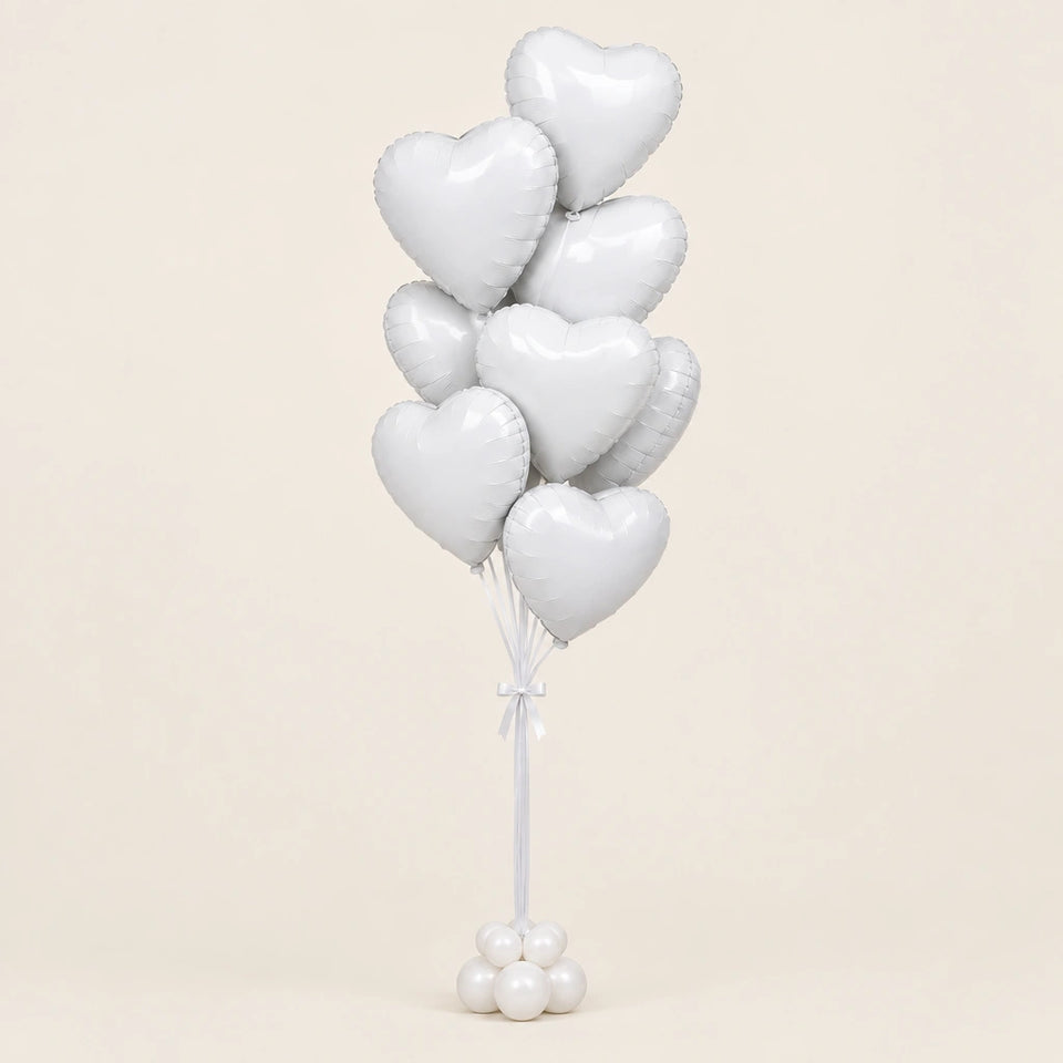 Ramo de globos de corazón blancos con base de globitos, sobre fondo beige